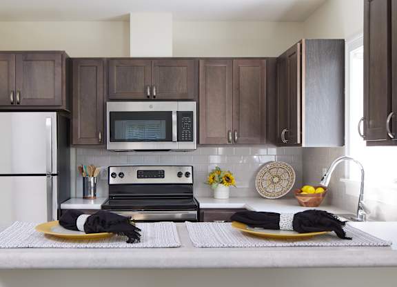 kitchen with stainless steel appliances and oak cabinets at Atlantic Pointe, Maine