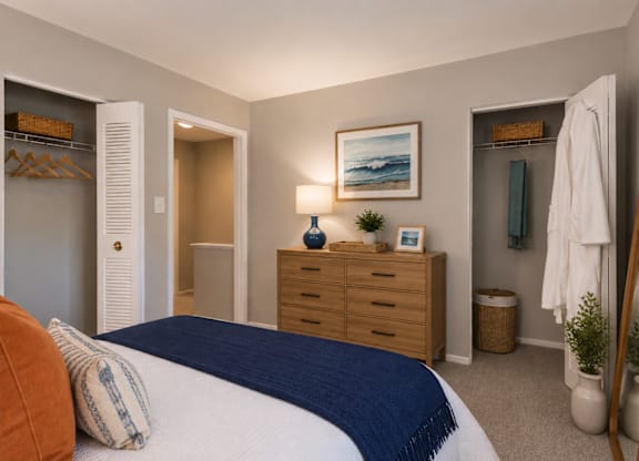 A bedroom with a bed, dresser, and mirror.