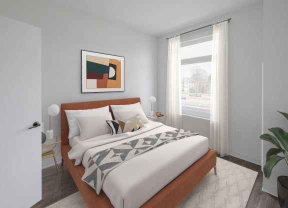 a bedroom with a large bed and a window