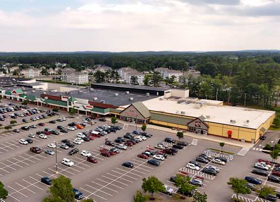A parking lot with a large building in the background.