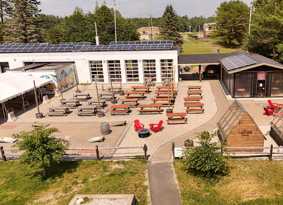 A park with a building, picnic tables, and a playground.