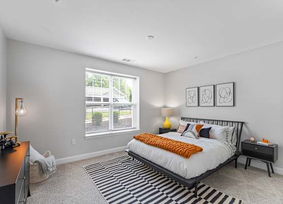 A bedroom with a large bed and a desk.