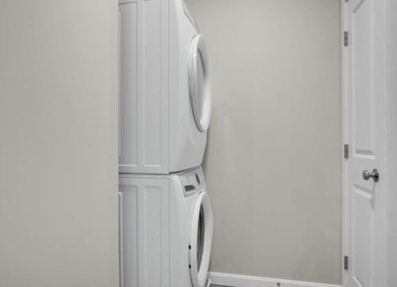 a white washer and dryer in a white room