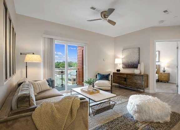 a living room with a couch and a ceiling fan