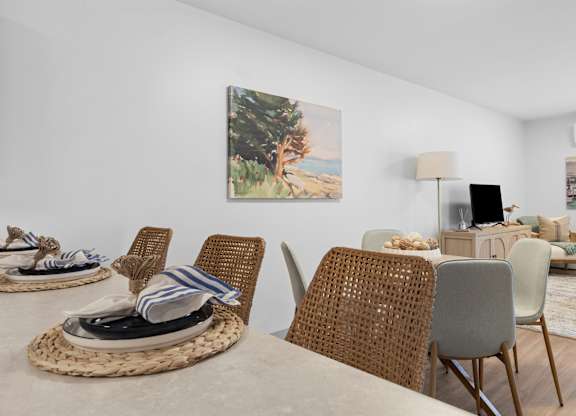 A dining room with a table set for four.