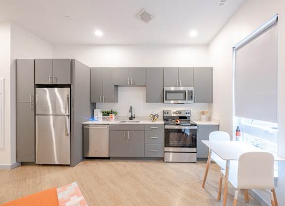 A modern kitchen with stainless steel appliances at Seacoast Residences Apartments, Maine, 03904