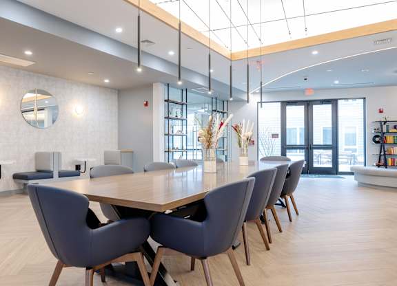 A conference room with a long table and chairs at Seacoast Residences Apartments, Maine, 03904