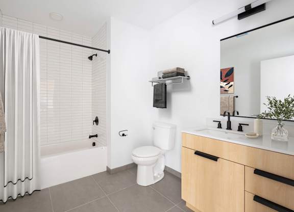 A white toilet sits next to a sink in a bathroom.