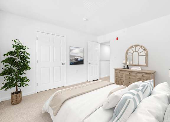 A bedroom with a bed, dresser, and a plant at Windsor Terrace, Hooksett, NH