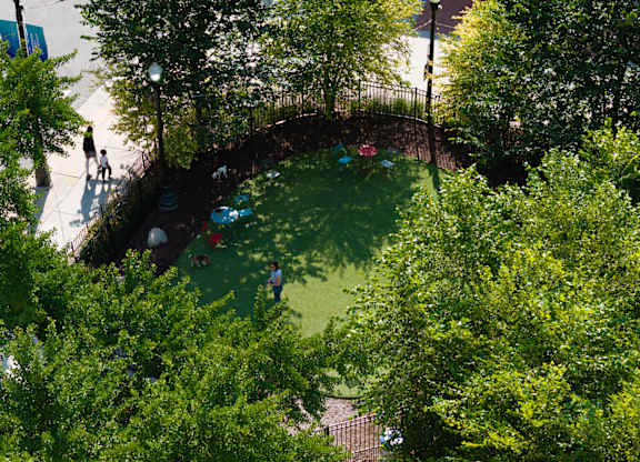 a birds eye view of a park with trees and people