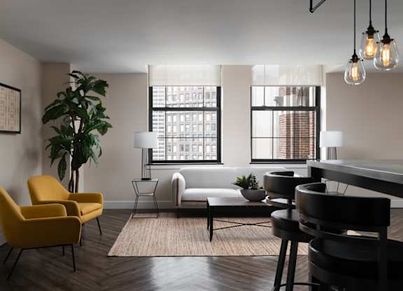 a living room with a piano and a table and chairs