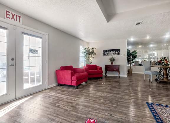 A living room with a red couch and a sign that says "EXIT".