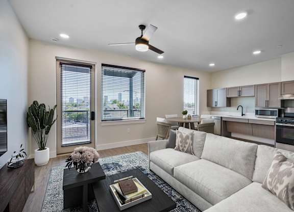 A modern living room with a large couch and a coffee table.
