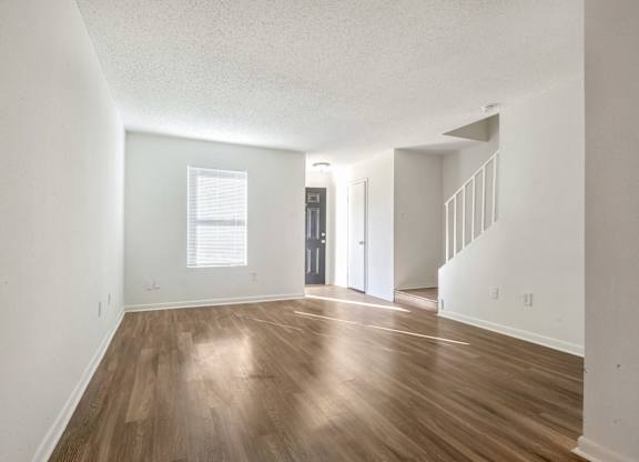 A room with wooden floors and white walls.