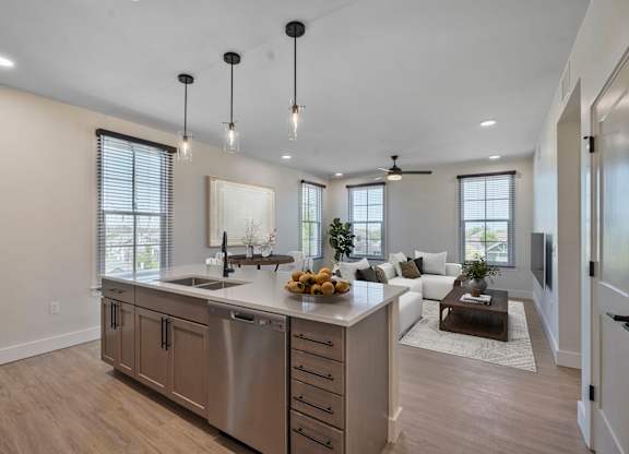 A modern kitchen with a large island and stainless steel appliances.