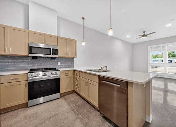A kitchen with a stove, oven, and microwave.