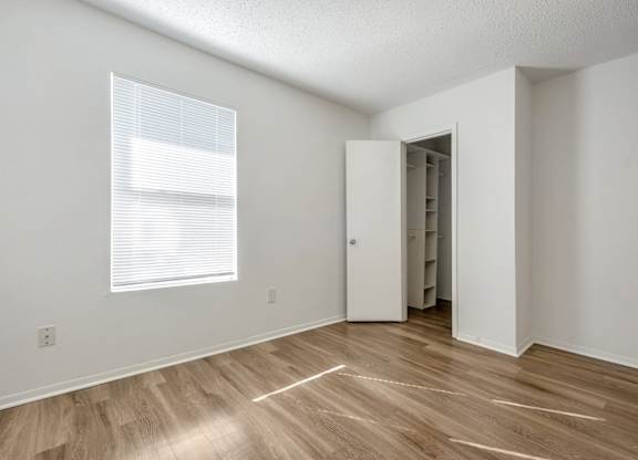 A room with a wooden floor and a white door.