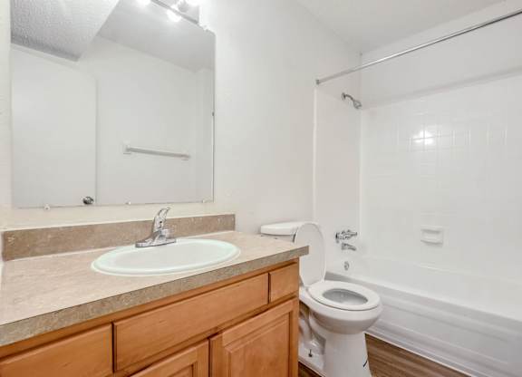 A white toilet sits next to a sink in a bathroom.