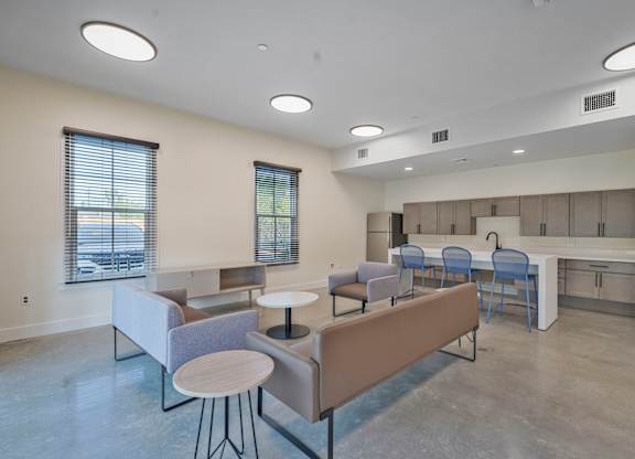 A modern living room with a grey sofa and a round table.
