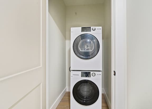 A white washing machine and dryer in a small laundry room.