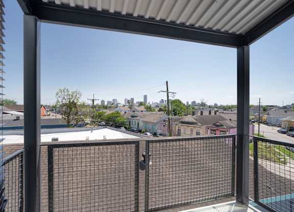 A view from a balcony looking out at a residential neighborhood.