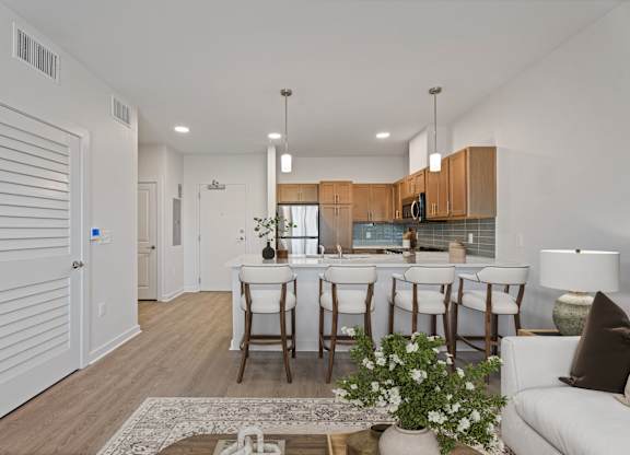 A modern kitchen with white cabinets and a dining table set with chairs.