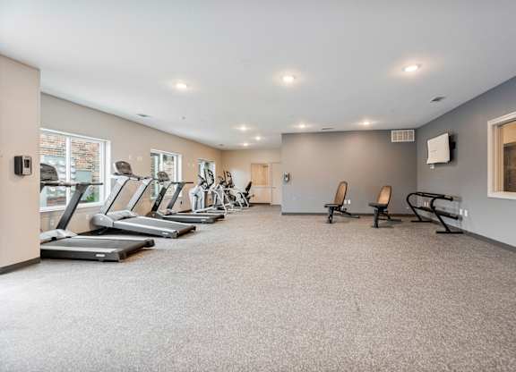 A spacious gym with treadmills and exercise machines.