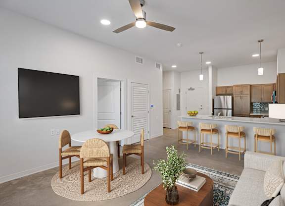 A modern living room with a dining table and chairs.