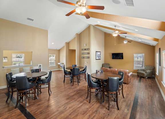 A living room with a dining table and chairs.