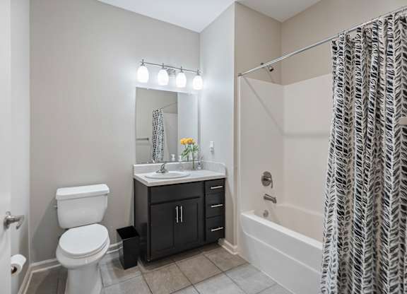 A bathroom with a toilet, sink, and bathtub.