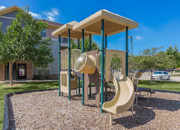A playground with a slide and a canopy.
