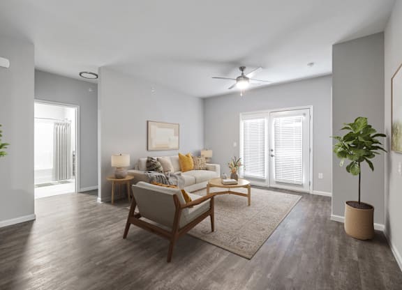 A living room with a brown chair and a brown rug.