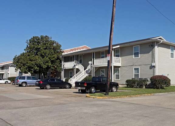 A two-story house with a garage and a truck parked in front.
