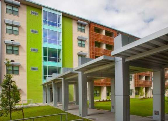 A modern building with a green and yellow facade.