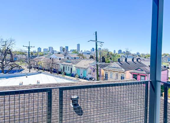 A view of a city skyline from a balcony.