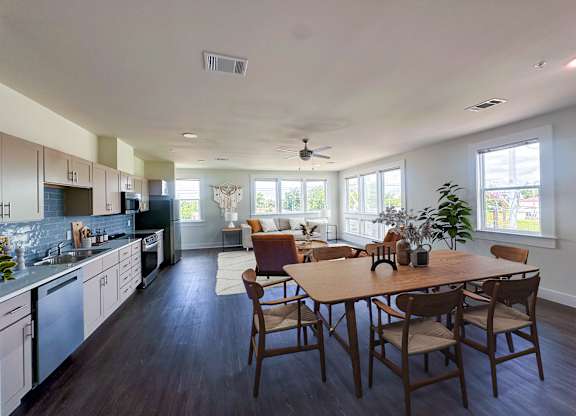 A modern kitchen with a dining table and chairs.