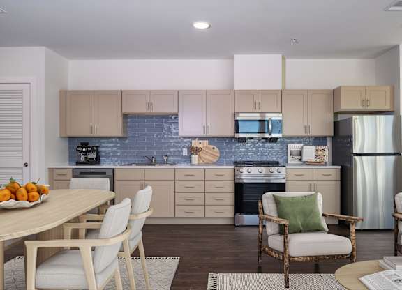 A kitchen with a table and chairs.