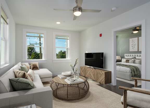 A living room with a white couch and a television.