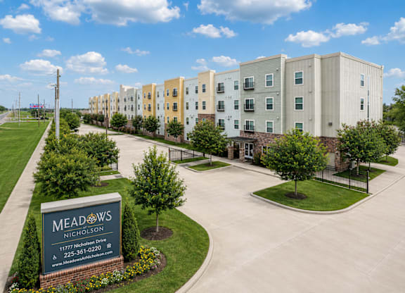 Meadows Nicholson apartment complex with a sign in front.