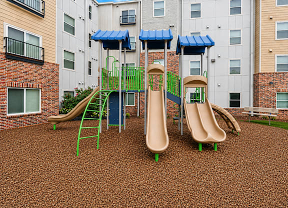 A playground with a slide and a climbing frame.