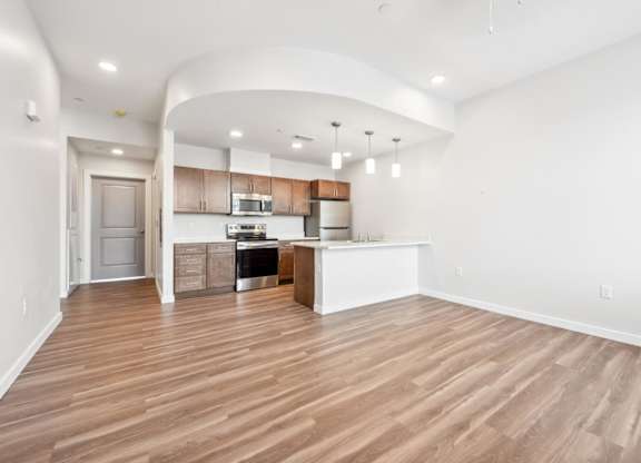 A kitchen with wooden floors and white walls.