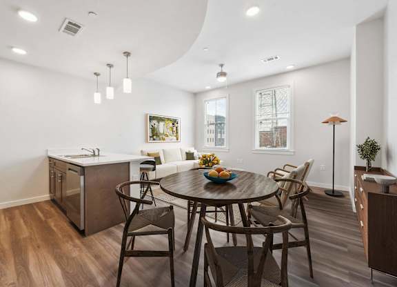A modern kitchen with a dining table set for four.