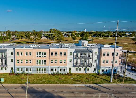 A large, multi-story building with a mix of pastel and neutral colors.
