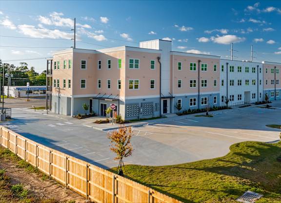 A large white building with a flag on the front.