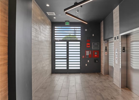 a view of a hallway with a door at the end of the hallway at The Fairfax Flats Apartments, Los Angeles, CA, 90019