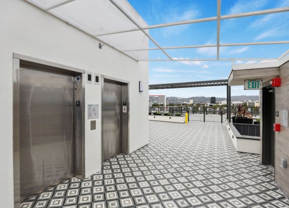 a view of the elevators on the top floor of the building at The Fairfax Flats Apartments, Los Angeles, CA