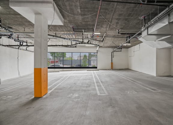 an empty parking lot with a large window in the background at The Fairfax Flats Apartments, California