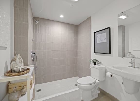 a bathroom with a sink toilet and bathtub at The Fairfax Flats Apartments, California, 90019