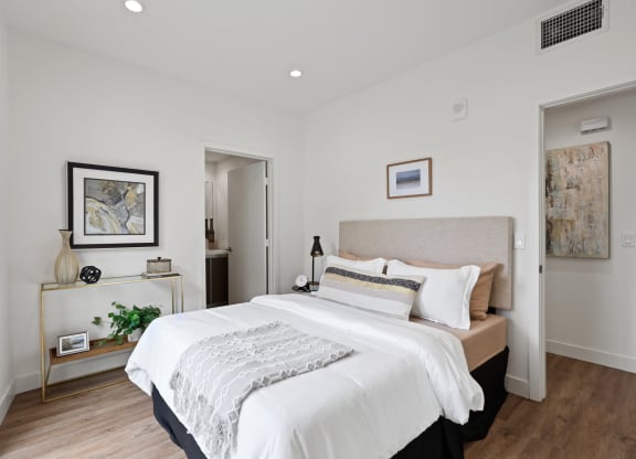a bedroom with a large bed in a room at The Fairfax Flats Apartments, California