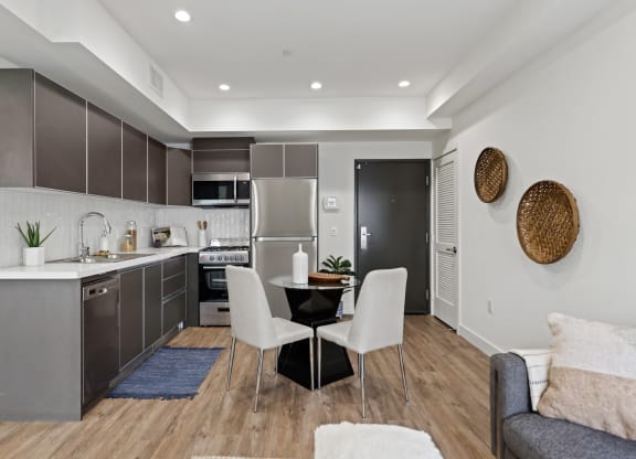 a kitchen and dining area in a 555 waverly unit at The Fairfax Flats Apartments, California